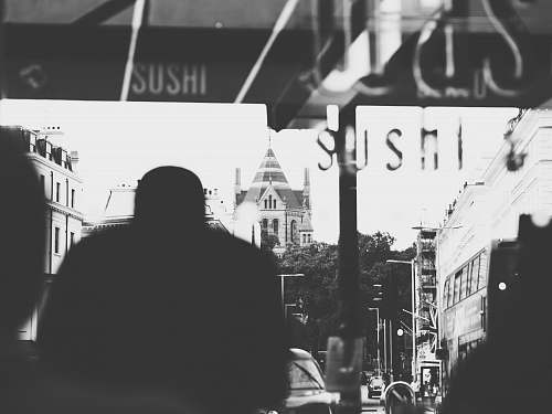 natural history museum grayscale photography of man inside bus london